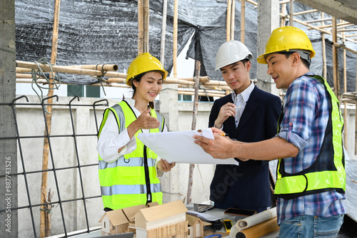 Male project manager and engineers discussing project details at building site