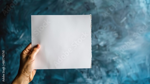 Space for text with white paper held by hand