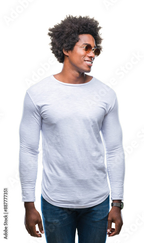 Afro american man wearing sunglasses over isolated background looking away to side with smile on face, natural expression. Laughing confident.