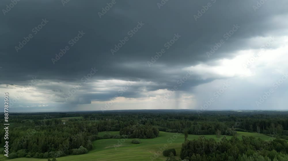 Epic time lapse of dark clouds on the sky, passing forward above green meadows and forests, copy space Epic time lapse of dark clouds on the sky, passing forward above green meadows and forests, copy space