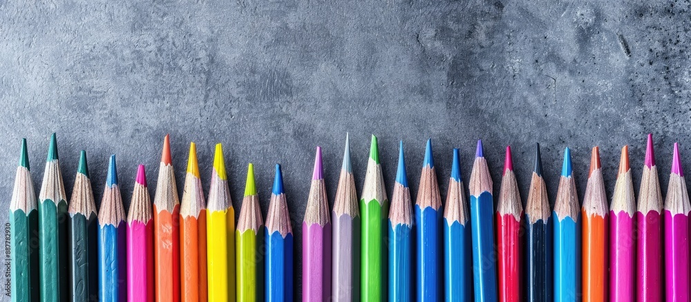 Colorful array of pencils set on a gray backdrop with versatile use in school office packaging and promotional settings providing a vibrant copy space image Colorful array of pencils set on a gray backdrop with versatile use in school office packaging and promotional settings providing a vibrant copy space image