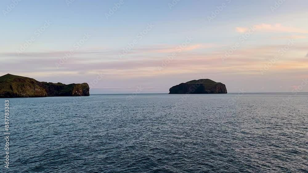 Vestmannaeyjar islands by coast of Iceland and open sea seen from boat Vestmannaeyjar islands by coast of Iceland and open sea seen from boat