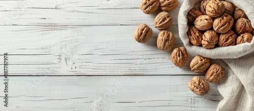Walnuts arranged on a white...