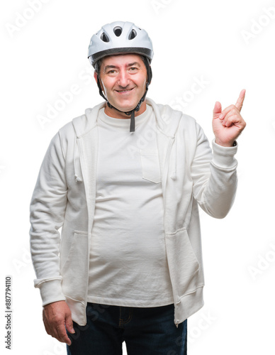 Handsome senior cyclist man wearing bike helmet over isolated background very happy pointing with hand and finger to the side