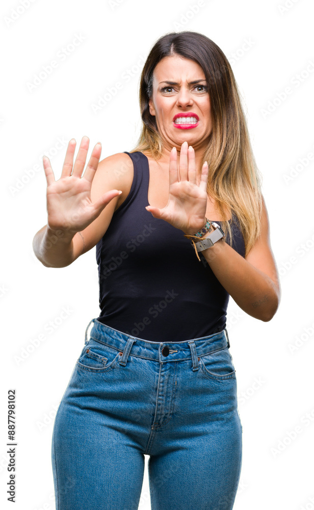 Young beautiful woman over isolated background afraid and terrified with fear expression stop gesture with hands, shouting in shock. Panic concept. Young beautiful woman over isolated background afraid and terrified with fear expression stop gesture with hands, shouting in shock. Panic concept.