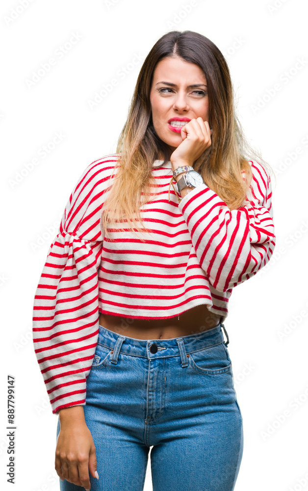 Young beautiful woman casual stripes winter sweater over isolated background looking stressed and nervous with hands on mouth biting nails. Anxiety problem. Young beautiful woman casual stripes winter sweater over isolated background looking stressed and nervous with hands on mouth biting nails. Anxiety problem.