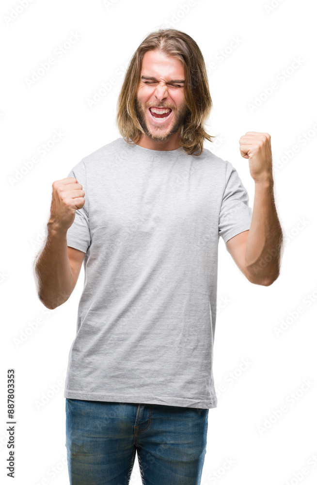 Young handsome man with long hair over isolated background very happy and excited doing winner gesture with arms raised, smiling and screaming for success. Celebration concept. Young handsome man with long hair over isolated background very happy and excited doing winner gesture with arms raised, smiling and screaming for success. Celebration concept.