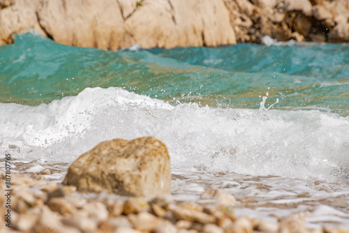 Fototapeta Naklejka Na Ścianę i Meble -  Amazing view of waterfront in Nugal beach in Makarska Riviera, between towns of Makarska and Tucepi. Dalmatia region of Croatia. Beautiful waves on a sunny summer day. Copy space. Selective focus