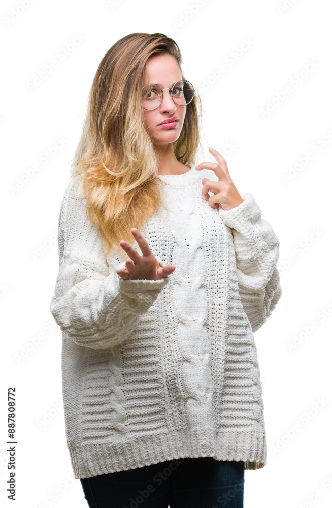 Φωτογραφία Young beautiful blonde woman wearing winter sweater and sunglasses over isolated background disgusted expression, displeased and fearful doing disgust face because aversion reaction