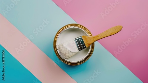 White paint can and brush on colorful surface palette selection for painting color samples catalog top down view photo