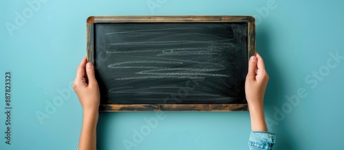 Hand holding a blank chalkb...