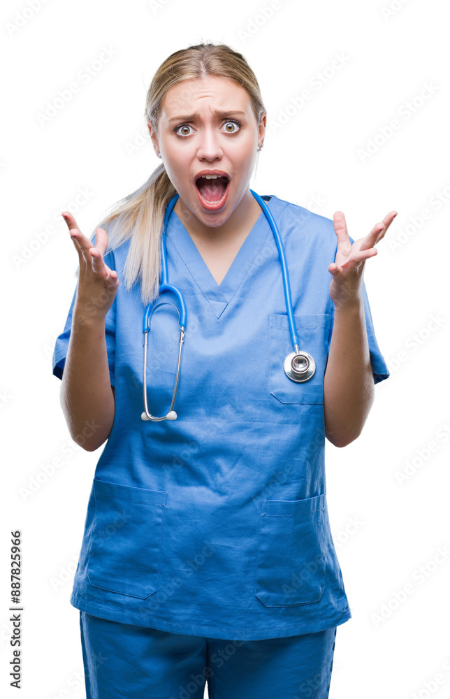 Young blonde surgeon doctor woman over isolated background celebrating crazy and amazed for success with arms raised and open eyes screaming excited. Winner concept Young blonde surgeon doctor woman over isolated background celebrating crazy and amazed for success with arms raised and open eyes screaming excited. Winner concept