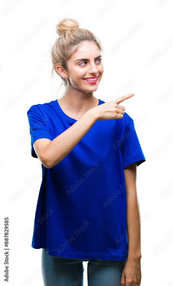 Young beautiful blonde and blue eyes woman wearing blue t-shirt over isolated background cheerful with a smile of face pointing with hand and finger up to the side with happy and natural expression Young beautiful blonde and blue eyes woman wearing blue t-shirt over isolated background cheerful with a smile of face pointing with hand and finger up to the side with happy and natural expression