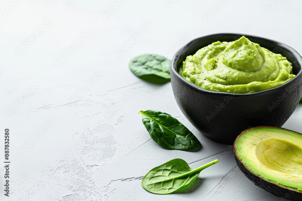 Obraz premium avocado-spinach dip in a matte black bowl