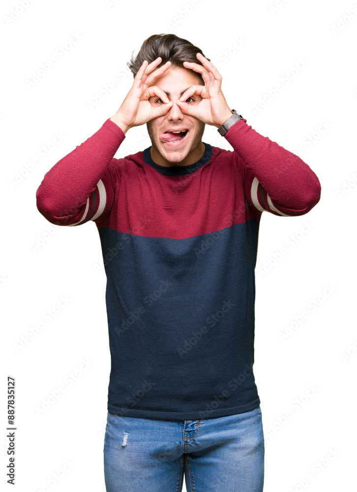 Young handsome man over isolated background doing ok gesture like binoculars sticking tongue out, eyes looking through fingers. Crazy expression. Young handsome man over isolated background doing ok gesture like binoculars sticking tongue out, eyes looking through fingers. Crazy expression.