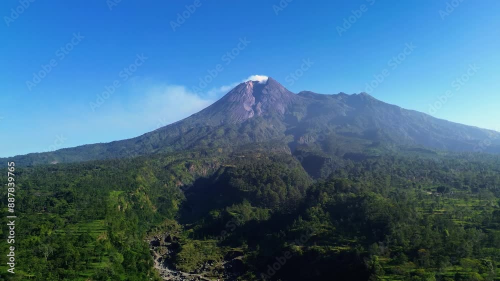 Aerial drone flight video of a panoramic view of Mount Merapi with beautiful views on a summer morning. 4k landscape of an active volcano in detail with a green forest in front of it Aerial drone flight video of a panoramic view of Mount Merapi with beautiful views on a summer morning. 4k landscape of an active volcano in detail with a green forest in front of it