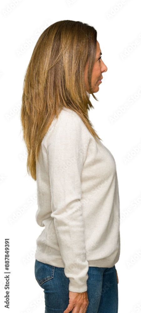 Beautiful middle age adult woman wearing winter sweater over isolated background looking to side, relax profile pose with natural face with confident smile. Beautiful middle age adult woman wearing winter sweater over isolated background looking to side, relax profile pose with natural face with confident smile.