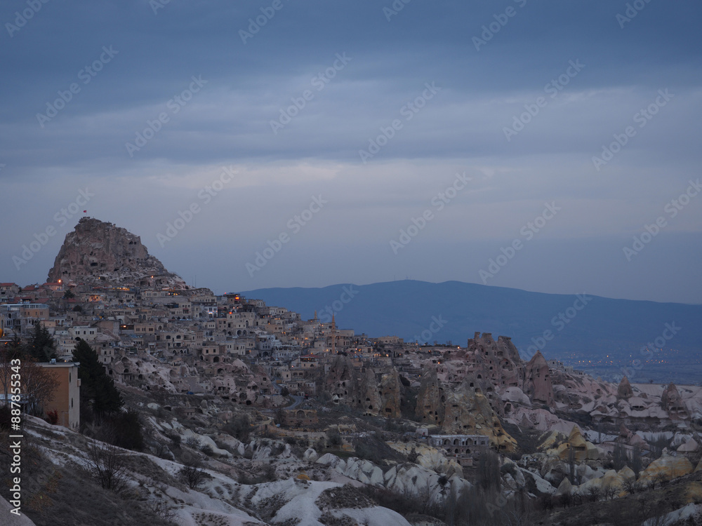 Fototapeta premium a landscape view of a rocky hillside with numerous cave-like openings and structures that seem to be carved into the rock