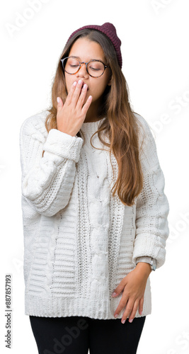 Young beautiful brunette hipster woman wearing glasses and winter hat over isolated background bored yawning tired covering mouth with hand. Restless and sleepiness.