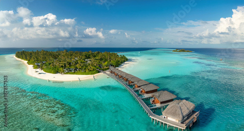 Aerial View of Maldives Island Luxury Water Villas Resort and Wooden Pier under a Beautiful Sky