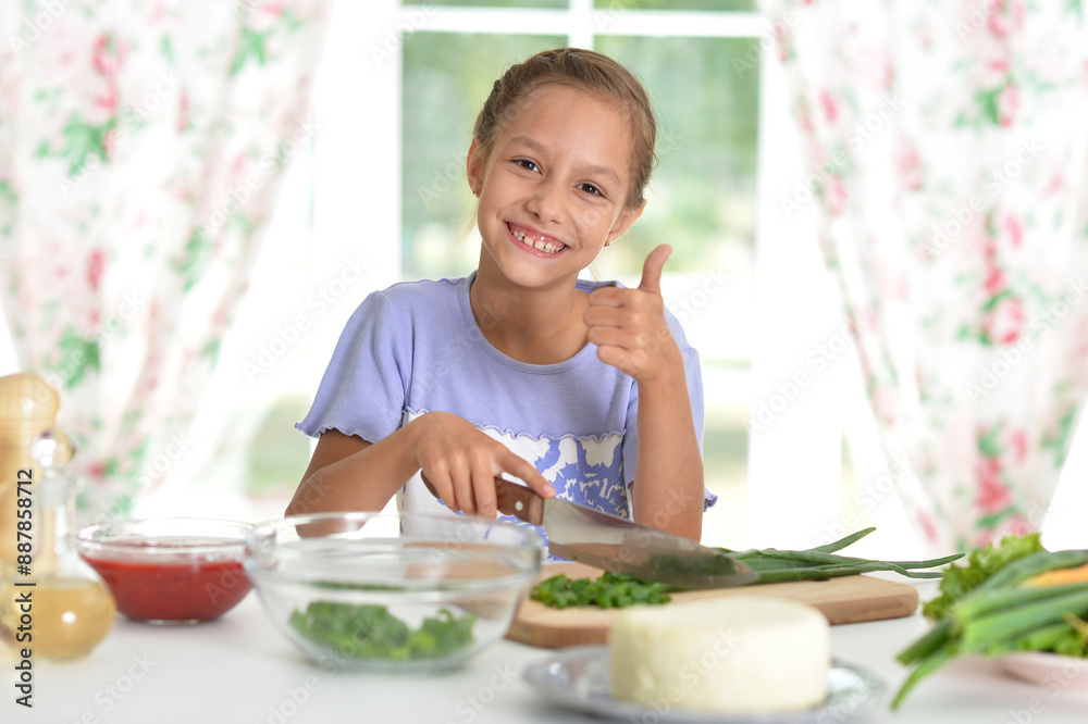 Cute happy girl coocking salad on kitchen Cute happy girl coocking salad on kitchen