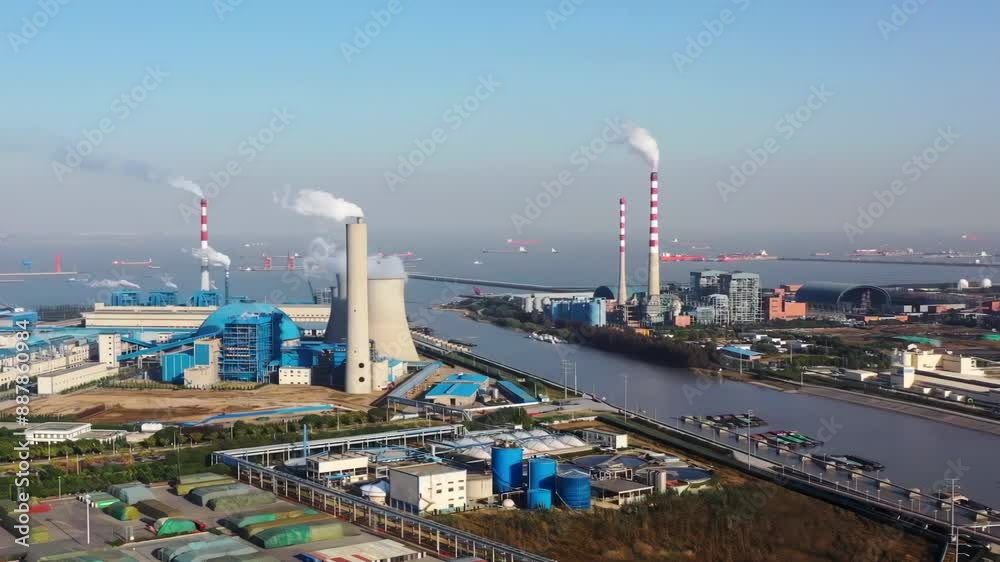 Aerial view of a coal fired steam power plant production of chemical products installation and port entrance for large ships Aerial view of a coal fired steam power plant production of chemical products installation and port entrance for large ships