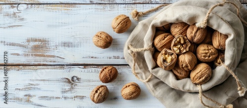 Walnuts arranged on a white...