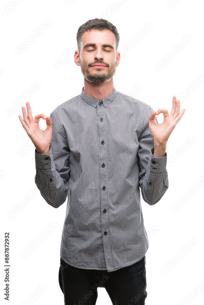 Young hipster man relax and smiling with eyes closed doing meditation gesture with fingers. Yoga concept. Young hipster man relax and smiling with eyes closed doing meditation gesture with fingers. Yoga concept.