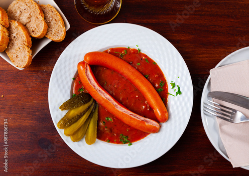 Traditional austrian food, boiled vienna sausages with goulash sauce in a restaurant photo