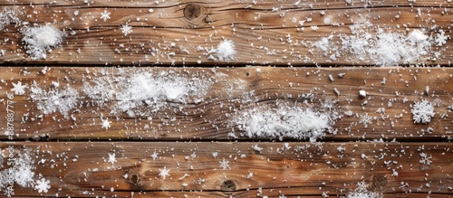 Snow dusted on a wooden bac...