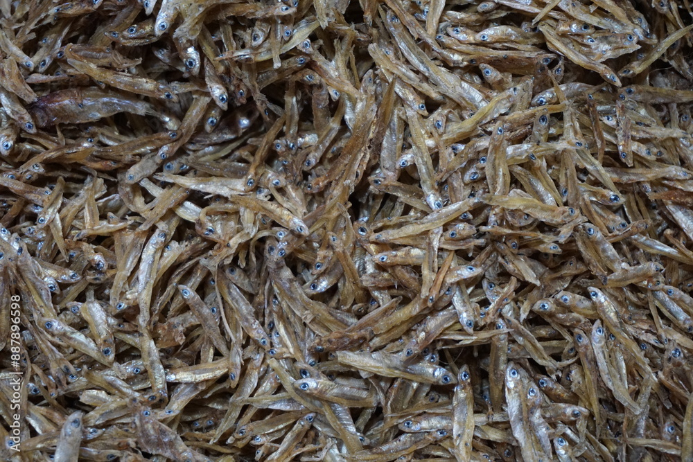 A pile of dried anchovies displayed in a fish market, Little dried fish in an Asian fish market, Fresh dried sardines and anchovies being displayed for selling at a seafood market A pile of dried anchovies displayed in a fish market, Little dried fish in an Asian fish market, Fresh dried sardines and anchovies being displayed for selling at a seafood market