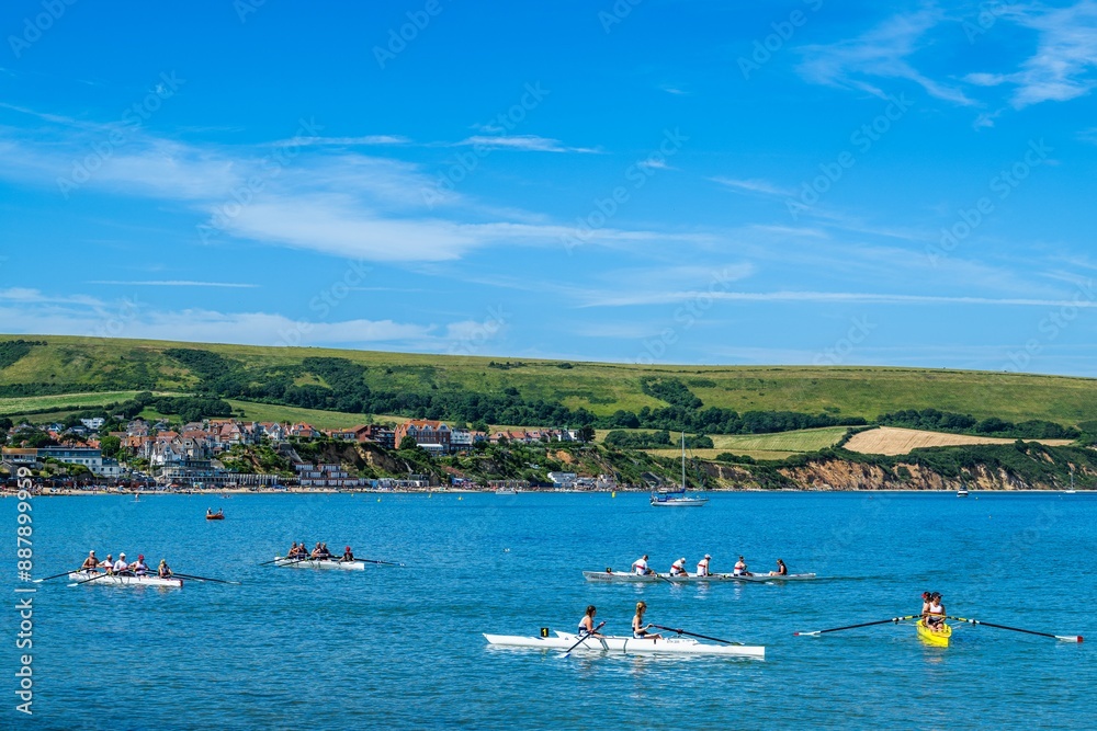 Fototapeta premium People in kayaks on Swanage Bay, Swanage, Dorset, England