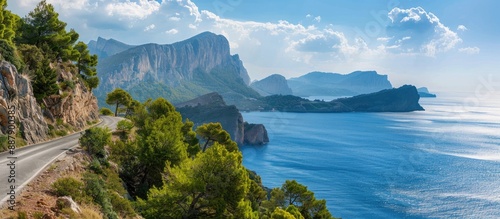 Fototapeta Naklejka Na Ścianę i Meble -  Scenic coastal mountain road with a view of the sea providing a background with ample copy space image