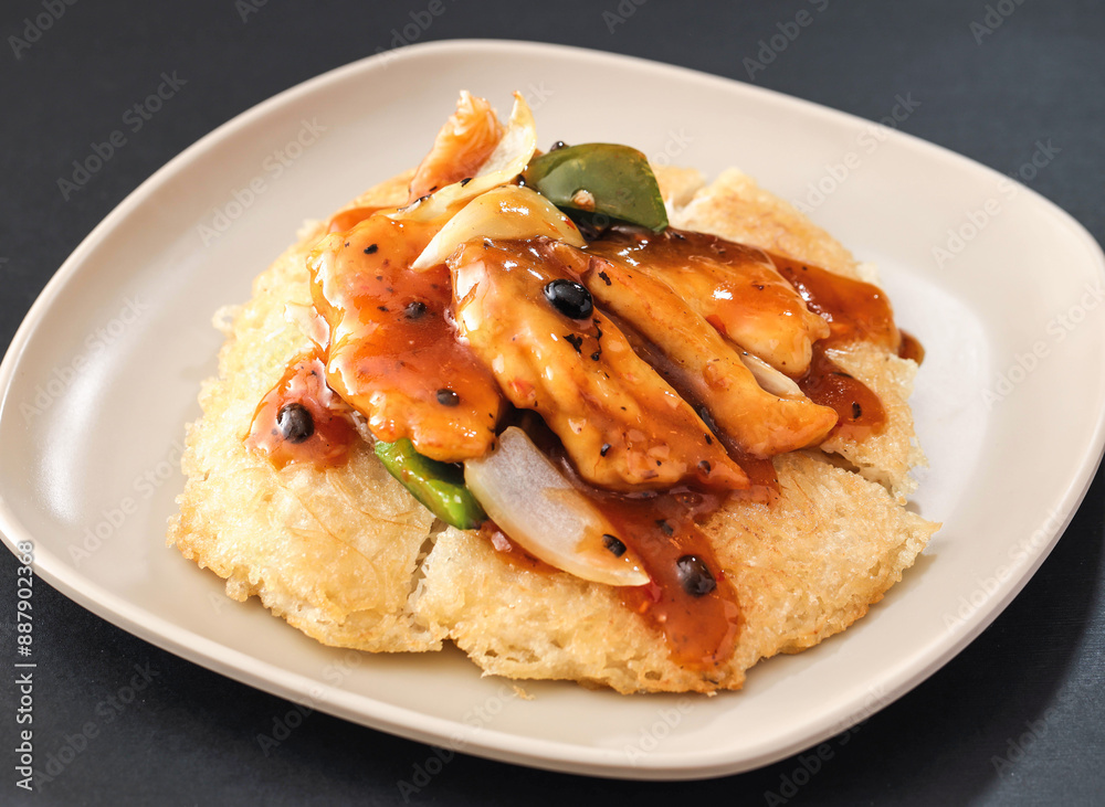 Pan fried rice noodles with black pepper, dragon and scallops served in dish isolated on background side view of hong kong food Pan fried rice noodles with black pepper, dragon and scallops served in dish isolated on background side view of hong kong food