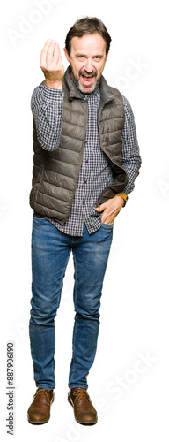 Middle age handsome man wearing winter vest Doing Italian gesture with hand and fingers confident expression