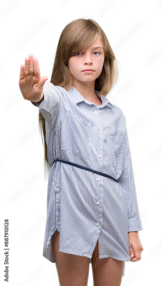 Young blonde toddler wearing blue shirt with open hand doing stop sign with serious and confident expression, defense gesture Young blonde toddler wearing blue shirt with open hand doing stop sign with serious and confident expression, defense gesture