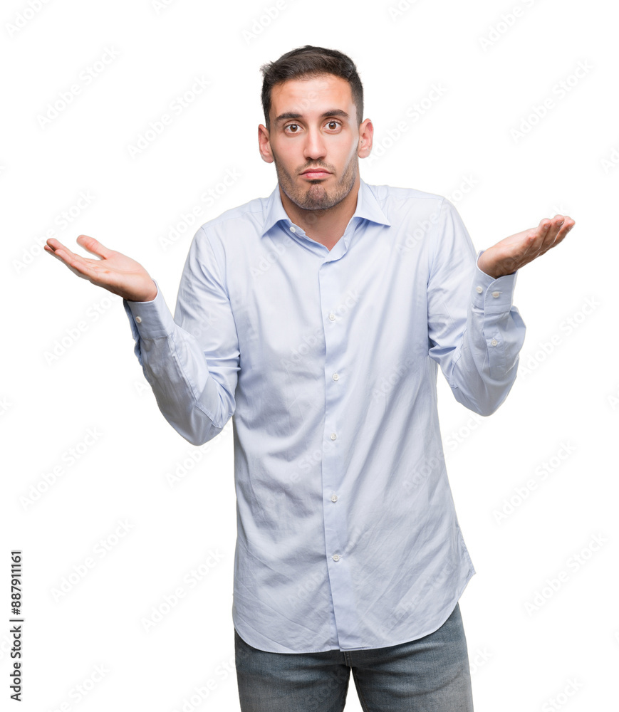 Handsome young businessman clueless and confused expression with arms and hands raised. Doubt concept. Handsome young businessman clueless and confused expression with arms and hands raised. Doubt concept.