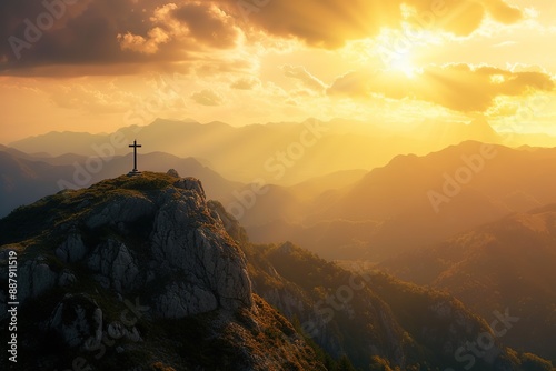 A majestic silhouette of a cross bathed in the golden glow of a setting sun atop a mountain peak. © Nopparat