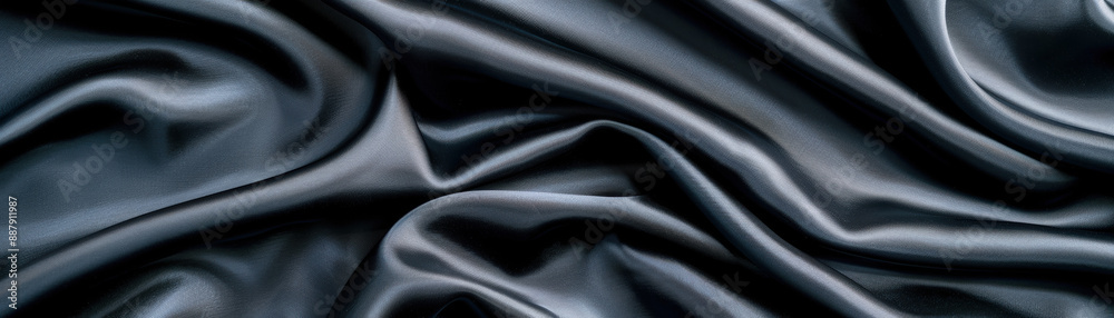 Obraz premium Smooth, dark satin fabric with elegant folds and a luxurious sheen, creating a soft and sophisticated texture for backgrounds or textiles.