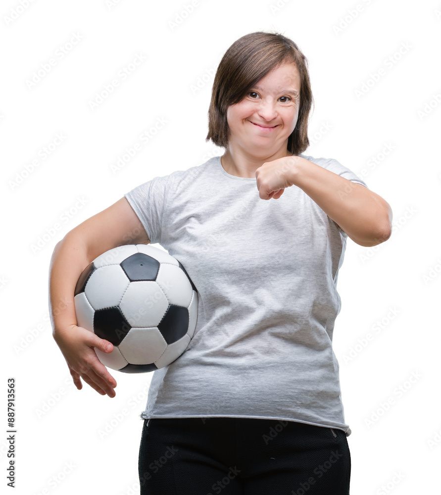 Young adult woman with down syndrome holding soccer football ball over isolated background with surprise face pointing finger to himself Young adult woman with down syndrome holding soccer football ball over isolated background with surprise face pointing finger to himself