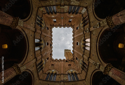 fisheye view through a building of a tower in siena italy