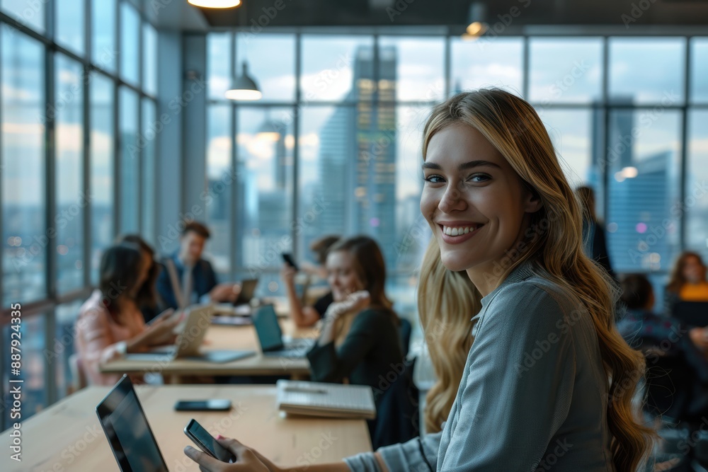 A smiling, happy businesswoman radiates warmth and positivity in the modern office environment, surrounded by her team. A smiling, happy businesswoman radiates warmth and positivity in the modern office environment, surrounded by her team.