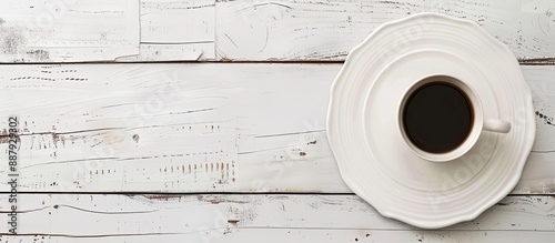 Empty plate and coffee cup on white table with copy space image