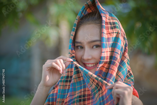 A pretty rural Asian woman lives a simple and happy life at home near rice fields with buffalo for seasonal farming. photo