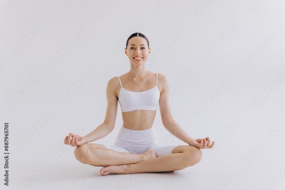 Sporty young woman with slim body doing yoga practice isolated on white background - concept of healthy life and natural balance between body and mental development Sporty young woman with slim body doing yoga practice isolated on white background - concept of healthy life and natural balance between body and mental development