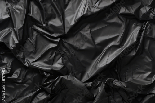 Processed collage of black cellophane garbage bag texture. Background for banner, backdrop