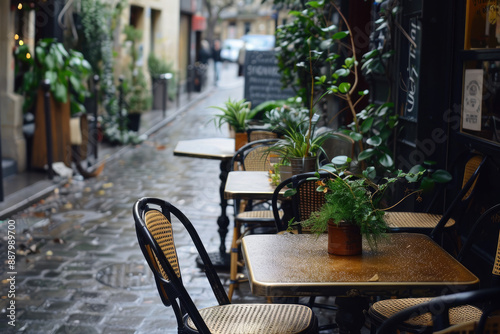 Fototapeta Naklejka Na Ścianę i Meble -  Cozy bistro setting with tables and chairs on a Parisian street