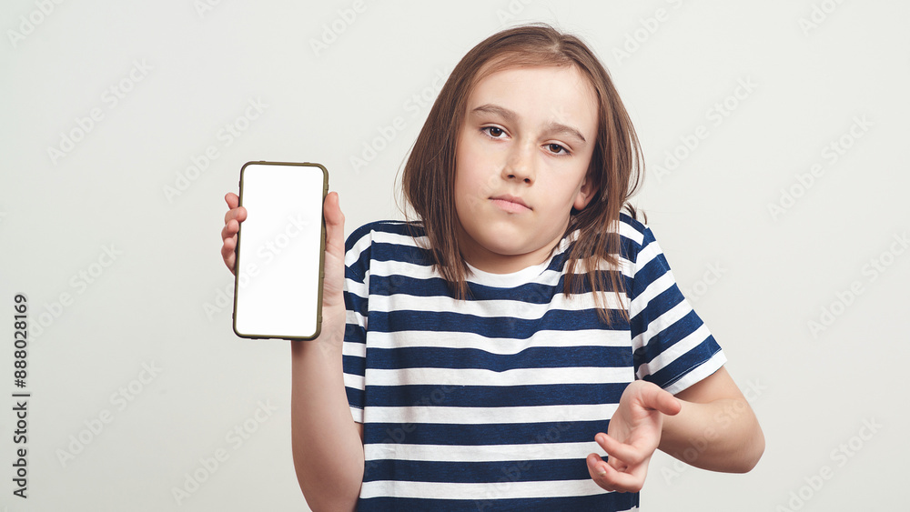 Serious boy holding mobile phone with white blank screen in hand. Gadget with empty free space for mock up. Serious boy holding mobile phone with white blank screen in hand. Gadget with empty free space for mock up.