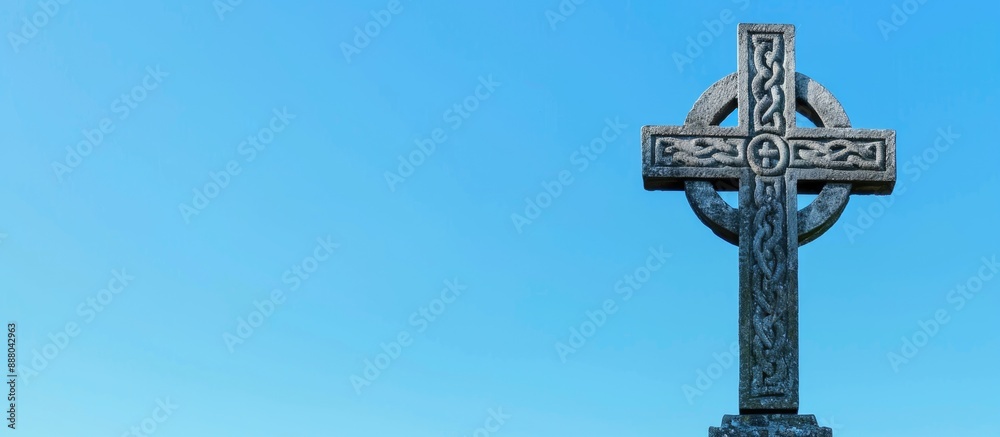 Celtic cross standing out against a clear blue sky in a photo with a blank space for additional content Celtic cross standing out against a clear blue sky in a photo with a blank space for additional content