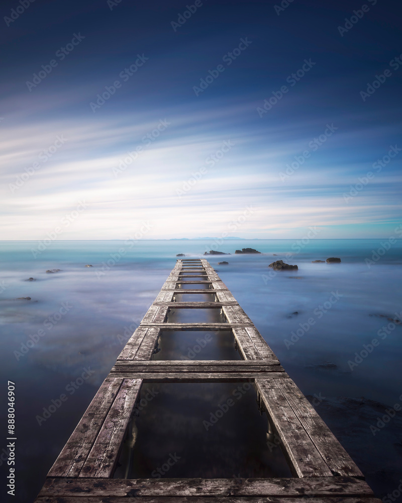 Obraz premium Wooden pier in a blue sea. Livorno, Long exposure photograph